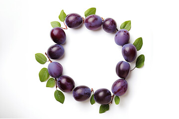 Round frame made of plums over white background