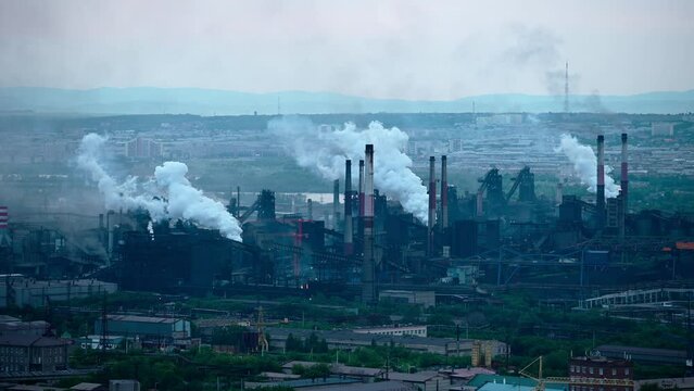 Factory pipes producing dirty smoke clouds. Metallurgical industry at Magnitogorsk city, Russia. Environmental contamination