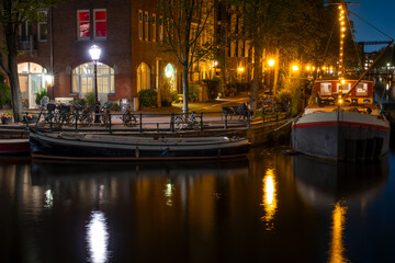 Night Amsterdam Quay with Bicycles and Houseboats