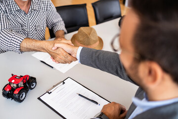 Signing contract and buying agricultural machines and farming equipment.