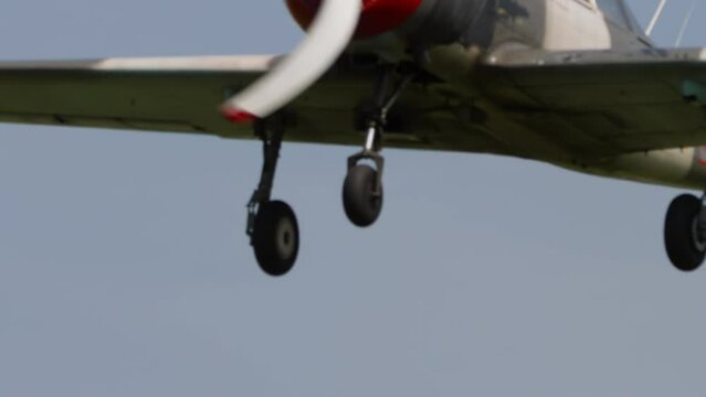 Retro plane flies at airshow. Two-seat sports trainer aircraft, designed for initial training and training of pilots. Soviet plane Yakovlev