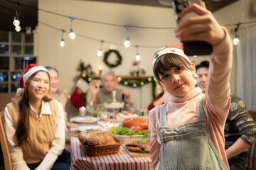 Happy family taking selfie photo with mobile phone at Christmas dinner party