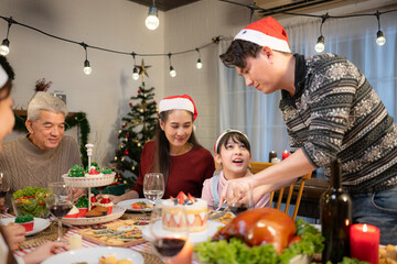 Happy asian family celebrating Christmas and New Year together at home.