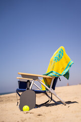 beach chair with pickleball paddle and ball