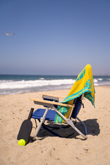 beach chair with pickleball paddle and ball
