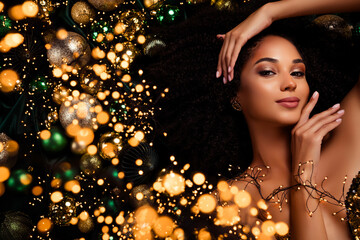 Top photo of charming chic lady touch face lying on christmas tinsels tree balls advertise season...