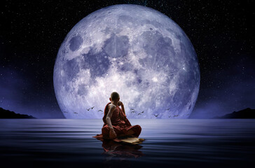 Buddhist monk observing the full moon
