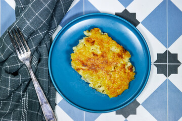 Mac and cheese. traditional american dish macaroni pasta and a cheese sauce on tiles background