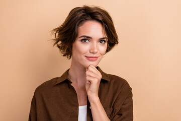Photo of good mood woman with bob hairstyle dressed brown shirt hold finger on cheen think business...