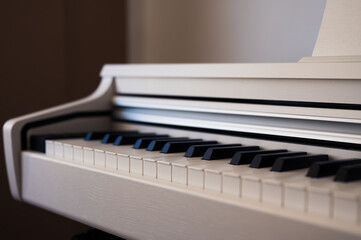 White upright piano. Classic piano keyboard with black and white keys. Musical image