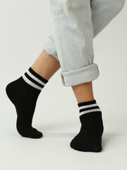 black and white socks with copy space on human feet closeup photo on white background