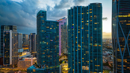 Naklejka premium modern skyline smart city cityscape of Miami Usa Florida downtown skyscraper illuminated at night sunset 