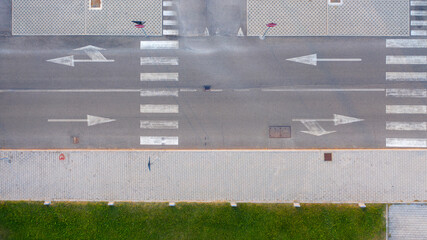 Aerial zenithal view of an empty road with road signs on the ground. © Stefano Tammaro