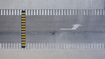 Aerial zenithal view of an empty road with an artificial speed bump.