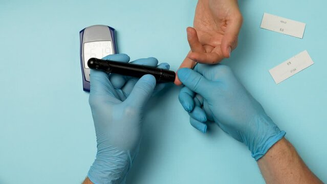 Doctor checking blood sugar level with glucometer.