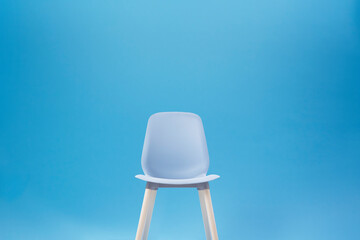 Blue classic chair on the blue backdrop for Chroma Key technique in the photo shooting studio for...