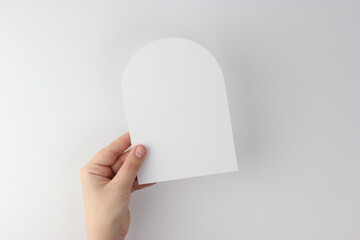 Card mockup in minimalist style, blank card in hand, arch card mockup