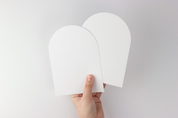Card mockup in minimalist style, two blank cards in hand, arch card mockup