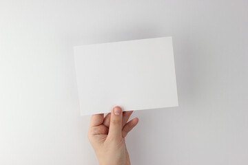 Card mockup in minimalist style, blank card in hand