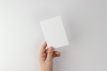 Card mockup in minimalist style, blank card in hand