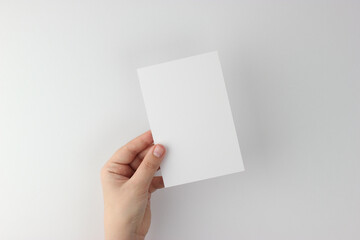 Card mockup in minimalist style, blank card in hand