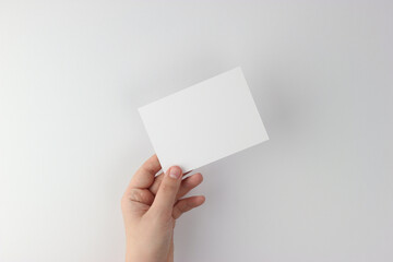 Card mockup in minimalist style, blank card in hand