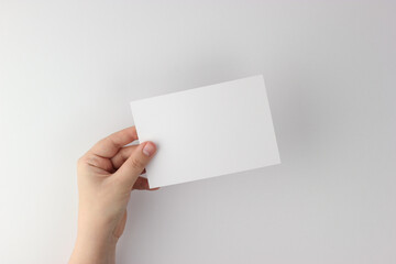 Card mockup in minimalist style, blank card in hand