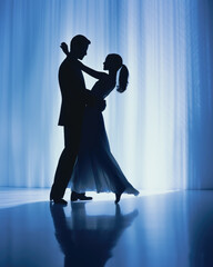 silhouette of a couple dancing in a ballroom, blue and bright curtains in the background wedding party opening dance, prom night banner  - obrazy, fototapety, plakaty
