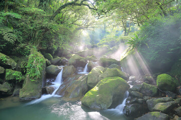 Beautiful river scenery of Taiwan in springtime, with refreshing cascades of a stream flowing down...