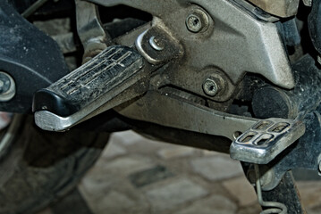 close up photo of footrest in a motorbike
