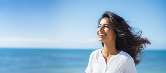 Fototapeta na wymiar Woman smiling by the ocean