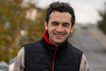 Armenian man, different emotional face actions, in the outdoor, the cold temperature, with the jacket, the man with a good smile