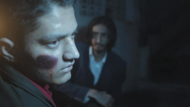 Close-up shot of an injured man with a cigarette in his mouth getting punched, movie-like scene set-up. HD footage.