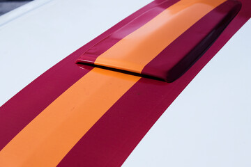 Color stripes on the hood of a classic car. Spain flag
