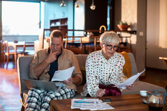 Mature Couple Reviewing Finances at Home