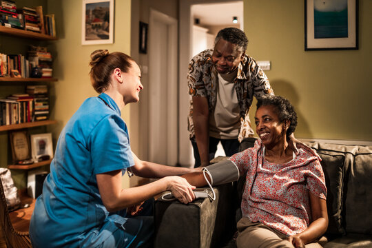 Caring Nurse Monitoring Blood Pressure While Couple Shares a Moment