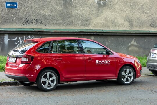 Red Skoda Rapid Spaceback NH1 of Sharp company parked on a street