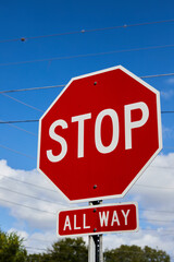 Bright red Stop sign, blue sky