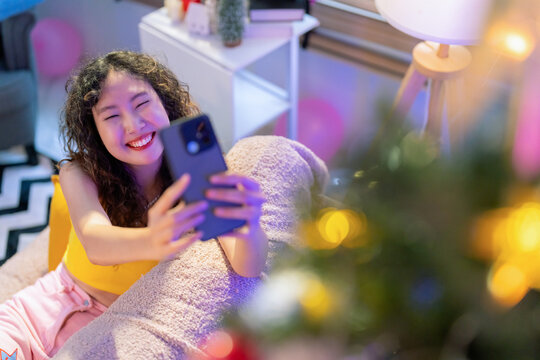 happiness young adult asian teen woman capture wonderful moment beautiful decorative christmas tree decorate for her social account for share and post woman taking chrsitmas tree photo