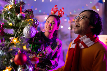 christmas party festive event group of asian friend helping decorate arrange christmas tree with...