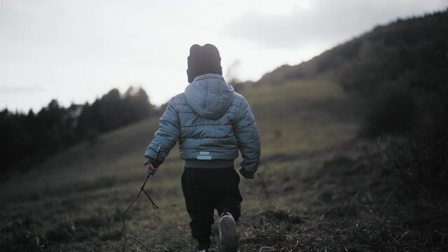 Child walking in a valley