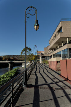 view of court street with streetlight from binghamton river walk pedestrian path along chenango (downtown historic district with urban architecture, buildings, street lamp) city park
