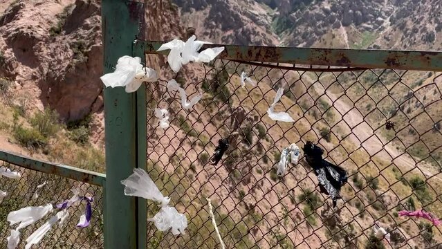 ribbons of desires tied to fancy against backdrop of a mountain and blue sky on Chimgan mountain, Uzbekistan