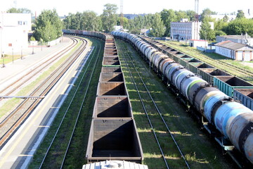Freight trains are at the railway station.	