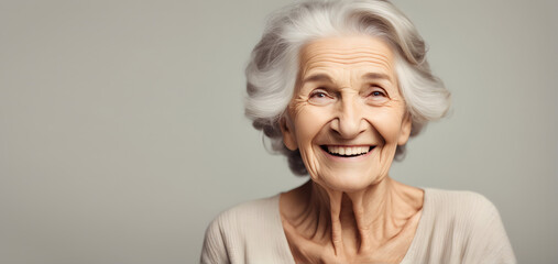 Smiling elderly woman on plain background