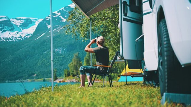 Tourist Spotting Wildelife in Front of His Camper Van RV