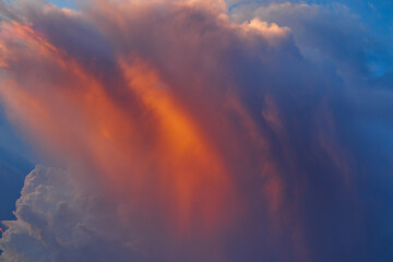 Twilight blue sky with bands of orange-shaded clouds floating gently.