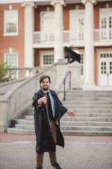 White male college grad on a brick campus