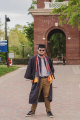 Fototapeta premium White male college grad on a brick campus