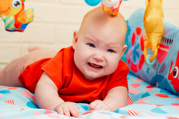 Portrait of cute baby a newborn girl playing in the room